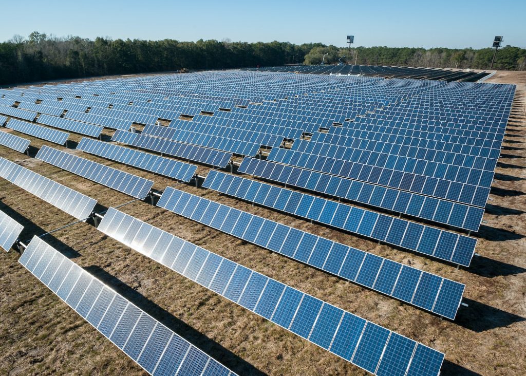 solar panel boards on brown ground - Glo Renewables
